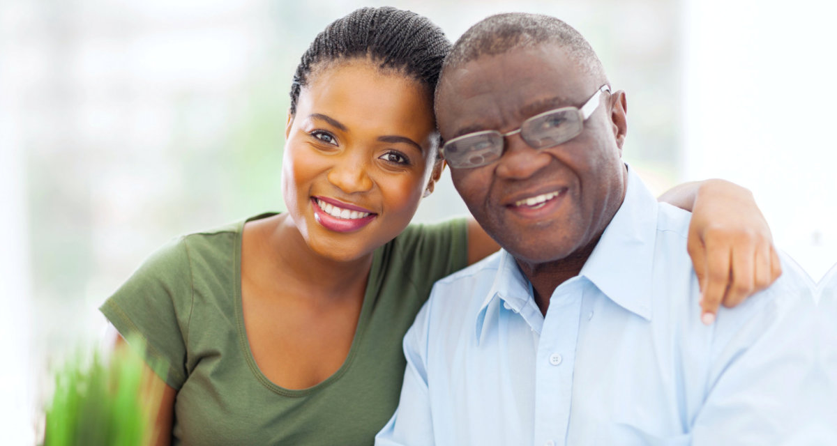 young lady and elder man looking at the camera smiling