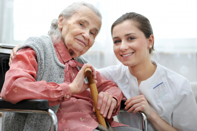 Senior woman with her caregiver at home