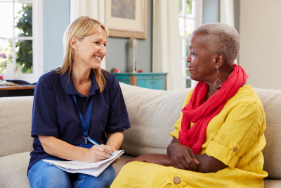 female caregiver visits senior woman at home